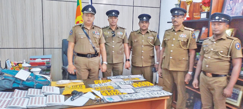 The seized heroin stock, cash and other confiscated items being examined by the officers including Mt. Lavinia SSP Mangala Dehidenia and OIC of the Divisional Crime Unit Chief Inspector Gamage Nilantha, at the Mt Lavinia Police Station.