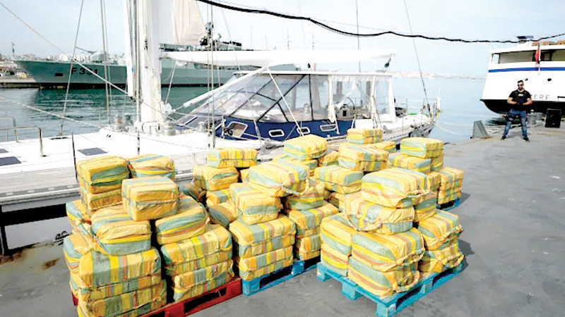 Bales of cocaine weighting some 5,2 tons and a seized yacht are displayed for the media at a Portuguese Navy base in Almada, South of Lisbon, on October18, 2021.
