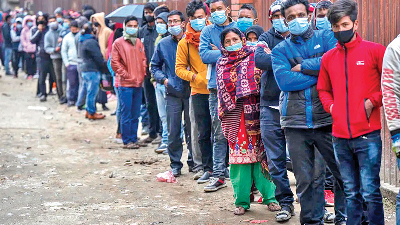 Nepalese people queue up to get vaccinated after the Government made vaccination cards mandatory for people to access public services in Kathmandu, Nepal on Friday.