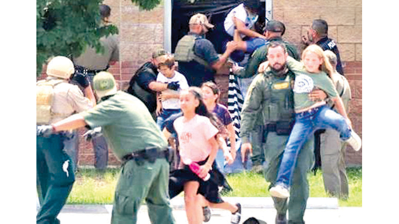 Children run to safety during a mass shooting at an elementary school where a gunman killed 19 children and two adults in Uvalde, Texas.