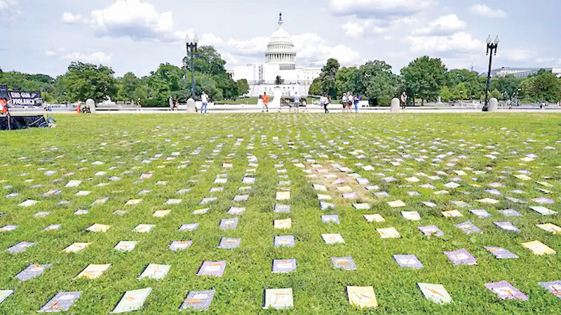 Laid out near the U.S. Capitol are 2,280 schoolbooks and broken pencils that represent the 2,280 children that have been killed by gun violence since the Senate has refused to bring a vote on background checks, during a rally in Washington on Friday.