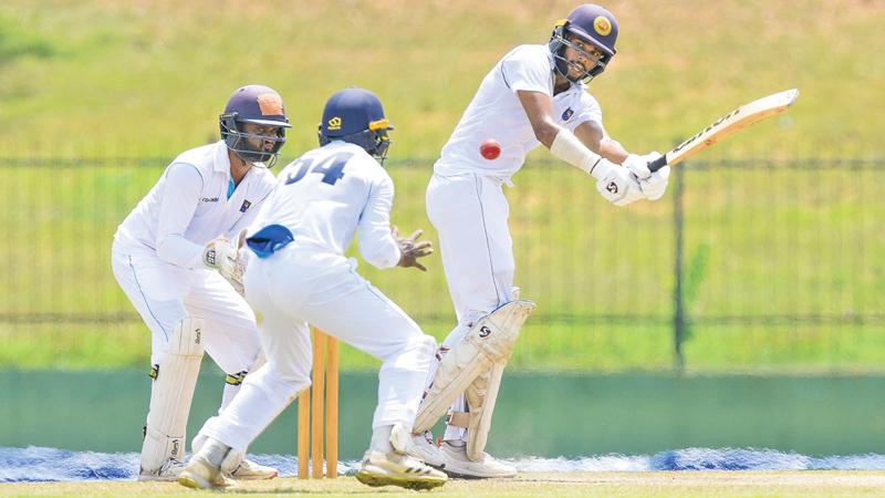 Jaffna opener Navod Paranavithnaha who scored an unbeaten 59 playing a stroke while Colombo wicket keeper Sithra Gimhan looks on. (Pic courtesy SLC)