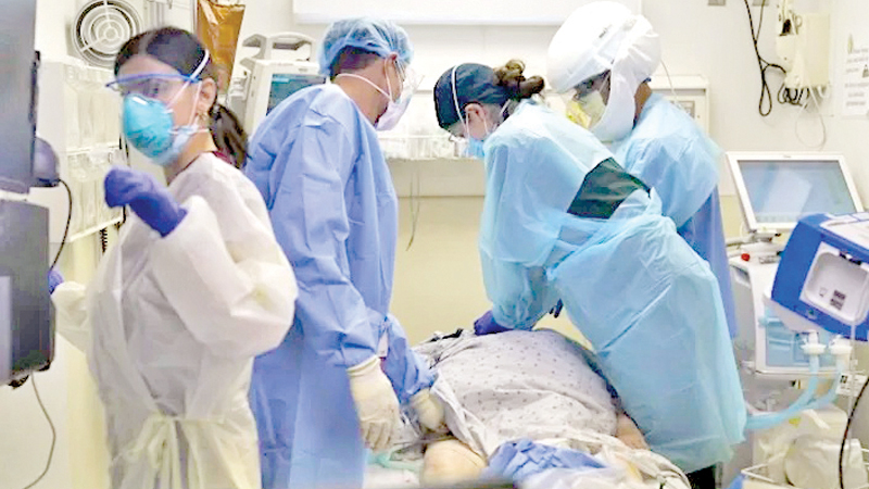 A doctor performs chest compression on a COVID-19 patient in the emergency room at Providence Holy Cross Medical Centre in Mission Hills, California.