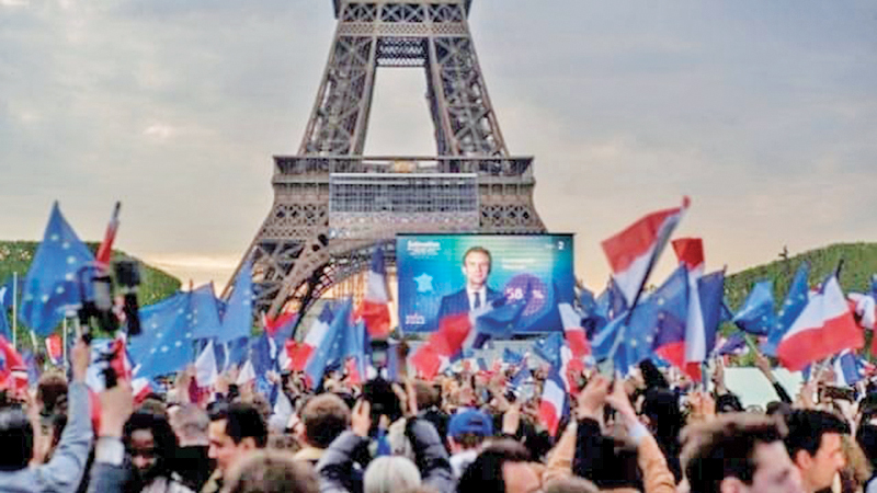 French President Emmanuel Macron celebrates with supporters in front of the Eiffel Tower  Paris, France on Sunday.