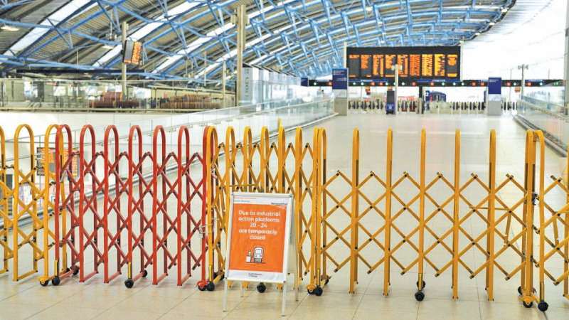 A sign states some platforms are closed during the industrial action at Waterloo railway station in London on Tuesday.
