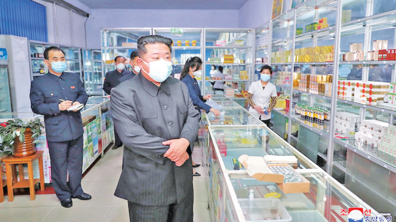 North Korean leader Kim Jong Un wears a face mask while inspecting a pharmacy in Pyongyang amid the COVID-19 outbreak.