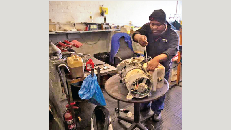 A man services a power generator at a store in Johannesburg