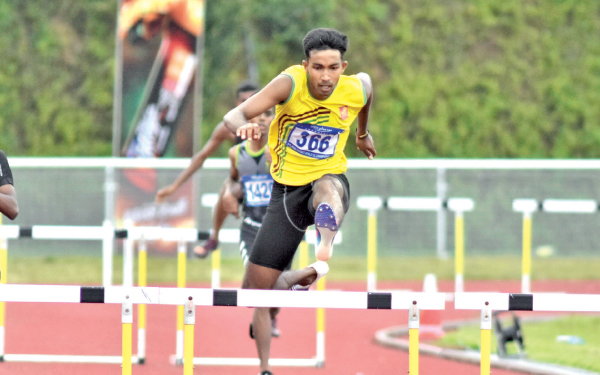 K.M.D Dharshana of Ambagamuwa Central in his record feat at the boys under 20 400m hurdles event.