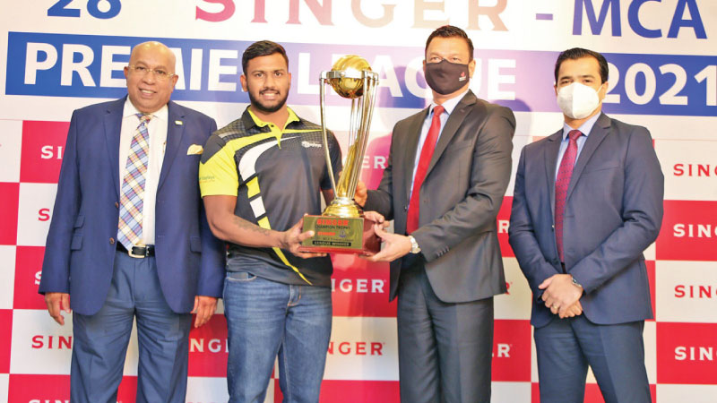 Hayleys Group skipper Avishka Fernando receiving MCA Premier League championship trophy from Singer Group Companies CEO Mahesh Wijewardena