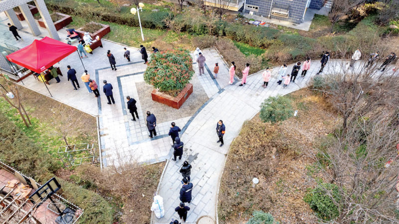 People line up during the fifth round of nucleic acid testing at a residential compound in Anyang, Henan Province, China on January 15, 2022.