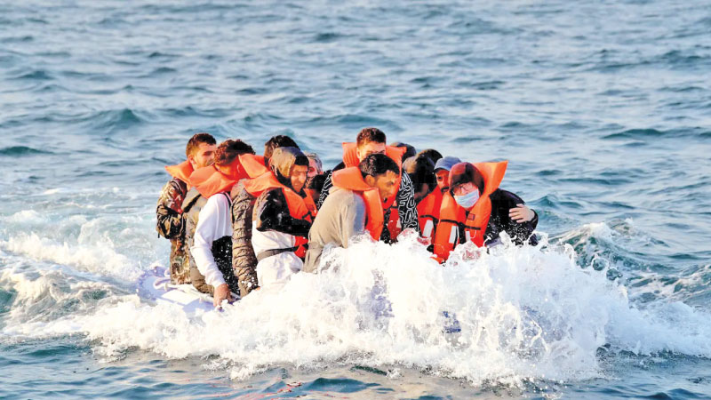 Migrants packed into a tiny dinghy were forced to bail out water after the raft started sinking while they were trying to cross the Channel.