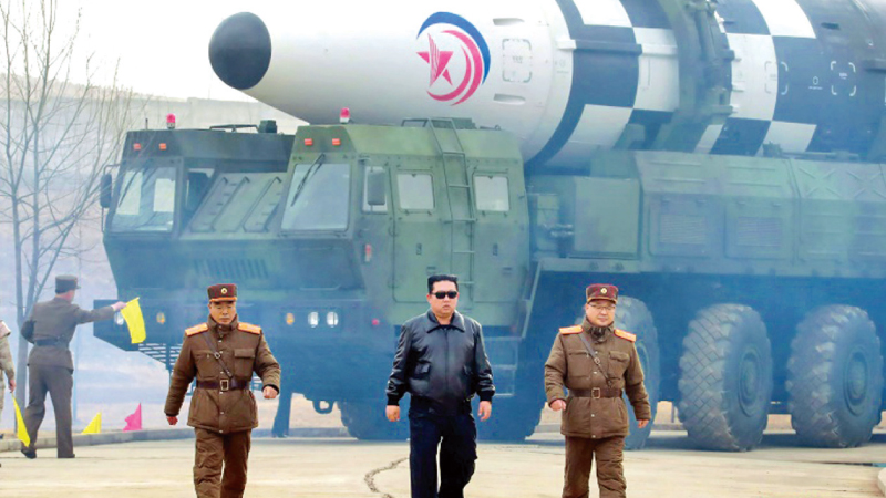 North Korean Leader Kim Jong Un (C) and military officers during a visit to one of the missile sites.