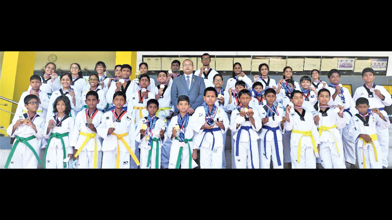 The President and Chief instructor of Elite Taekwondo Club Asitha Wickramatunga with his students after the award ceremony.