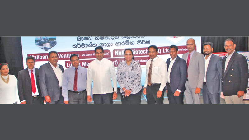Minister Prof. Channa Jayasumana flanked by new investors at the agreement signing ceremony. Picture by Wimal Karunatillike