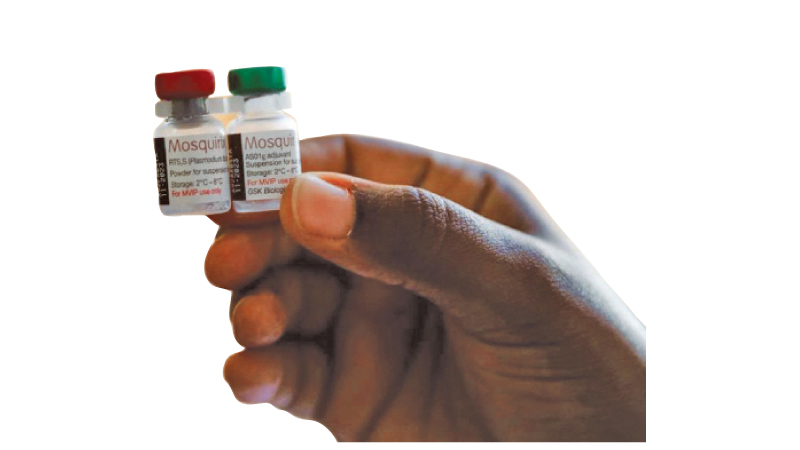 A nurse holds Malaria vaccine vials.