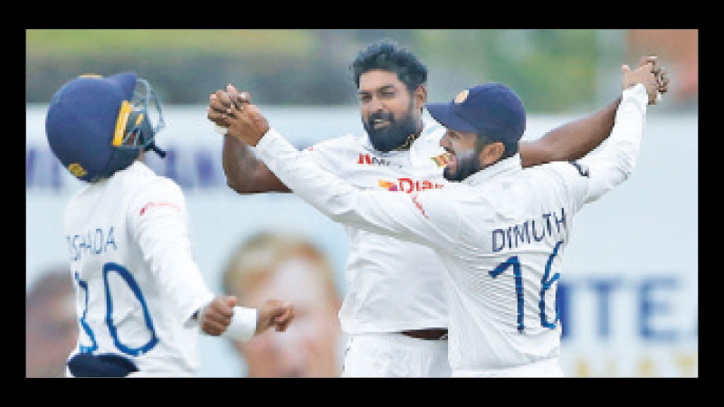 Sri Lankan bowling hero debutant spinner Prabath Jayasuriya celebrating a wicket with skipper Dimuth Karunaratne. (pix courtesy SLC)