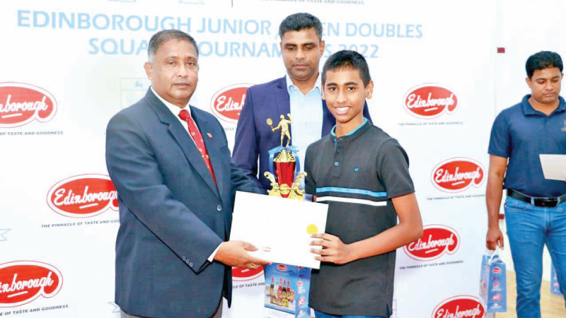 Matheesha Wijesekera the promising squash player receiving his under 15 champions trophy at the recently concluded Edinborough Open junior and doubles Squash Championship     