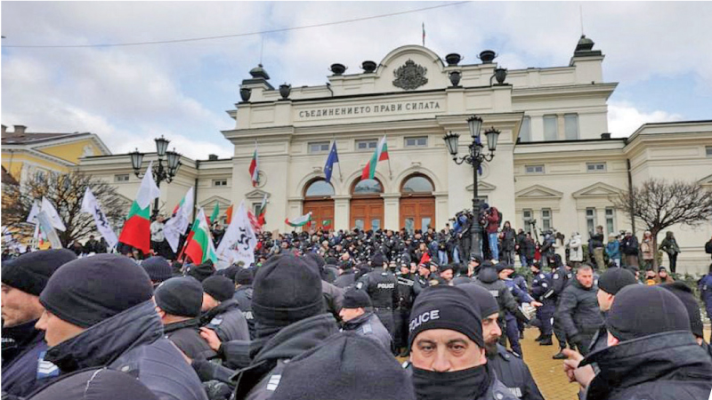 Police officers line up as they try to keep protesters away from the Bulgarian Parliament building in Sofia, Wednesday, January 12.