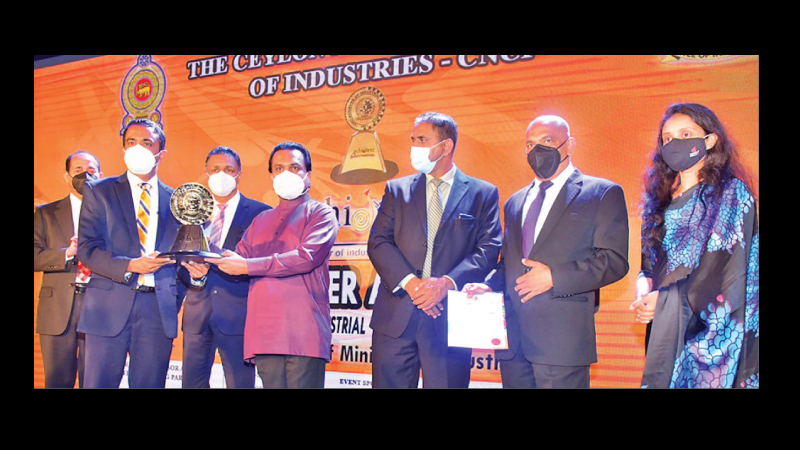 Chief Executive Officer of HNBA Lasitha Wimalaratne accepting the award from Minister Wimal Weerawansa. Chief Financial Officer of HNBA and HNBGI Punsirini Perera on the extreme right. Picture by Sudath Malaweera