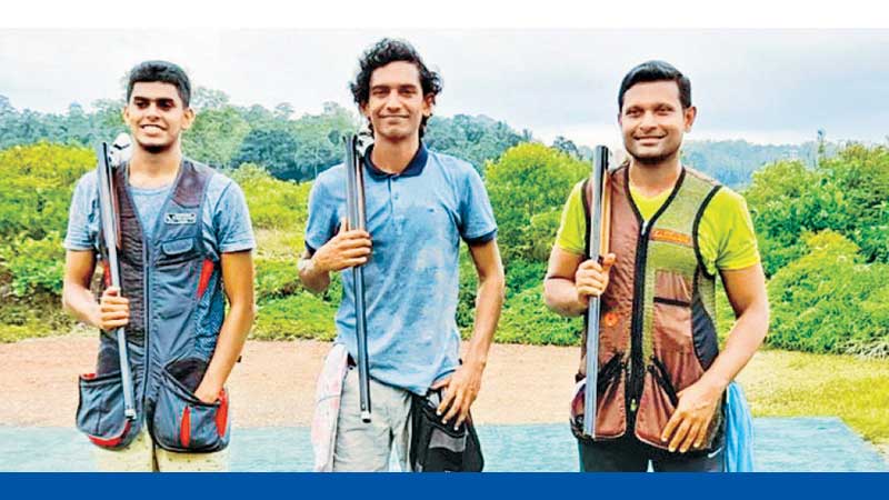 Champion shooter Jeremy Fernando flanked by Muditha Samaranayake (L) and Rishan Dias (R).