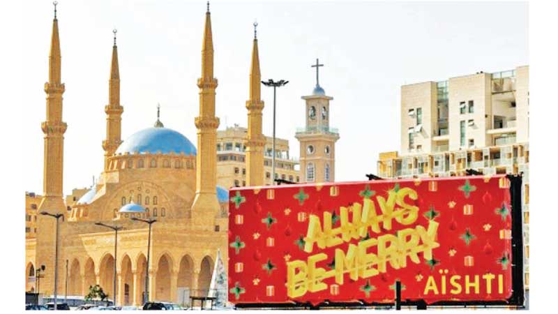 Trying to be positive: A Christmas greetings billboard in Beirut's Martyrs' Square, near the Mosque of Mohammed al-Amin and the Maronite Cathedral of Saint George.