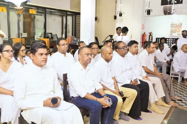The Lake House Management and staff at the all-night pirith chanting ceremony at the Lake House premises yesterday.