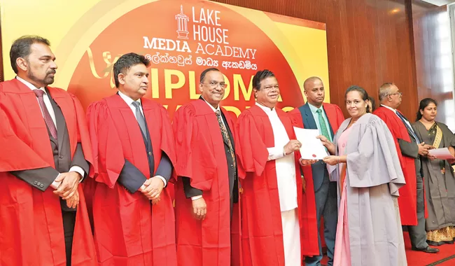 Diploma students receiving their certificates from the Minister of Mass Media
